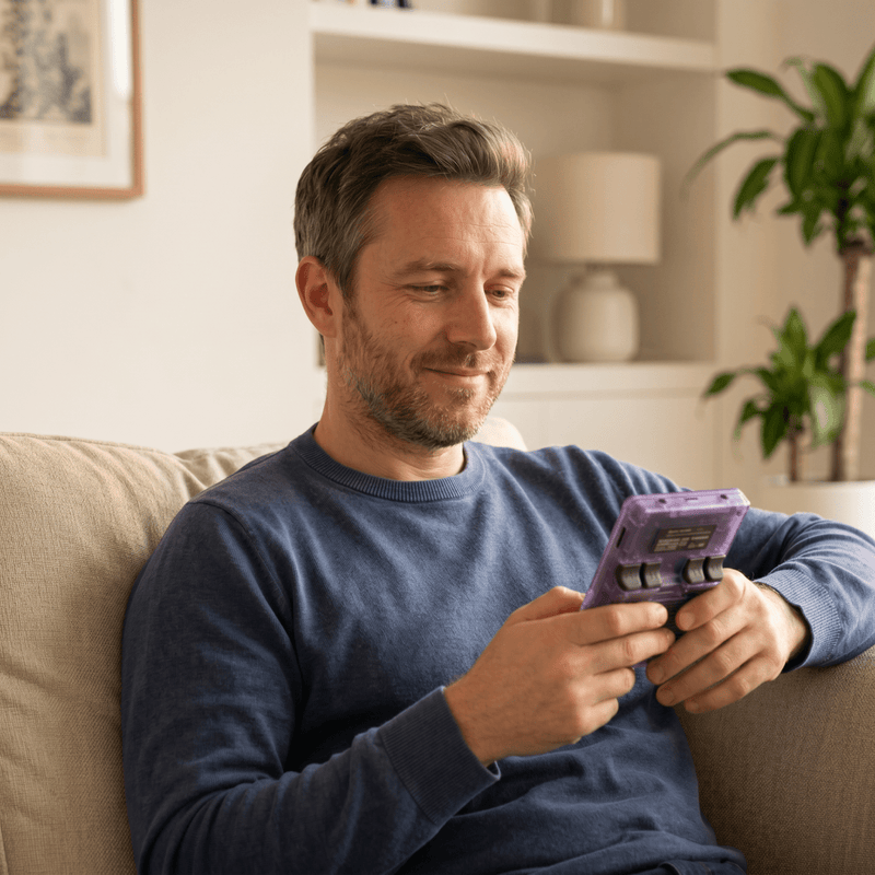 Person playing the Mysorvyn Pro 2.0 R36S retro gaming console at home